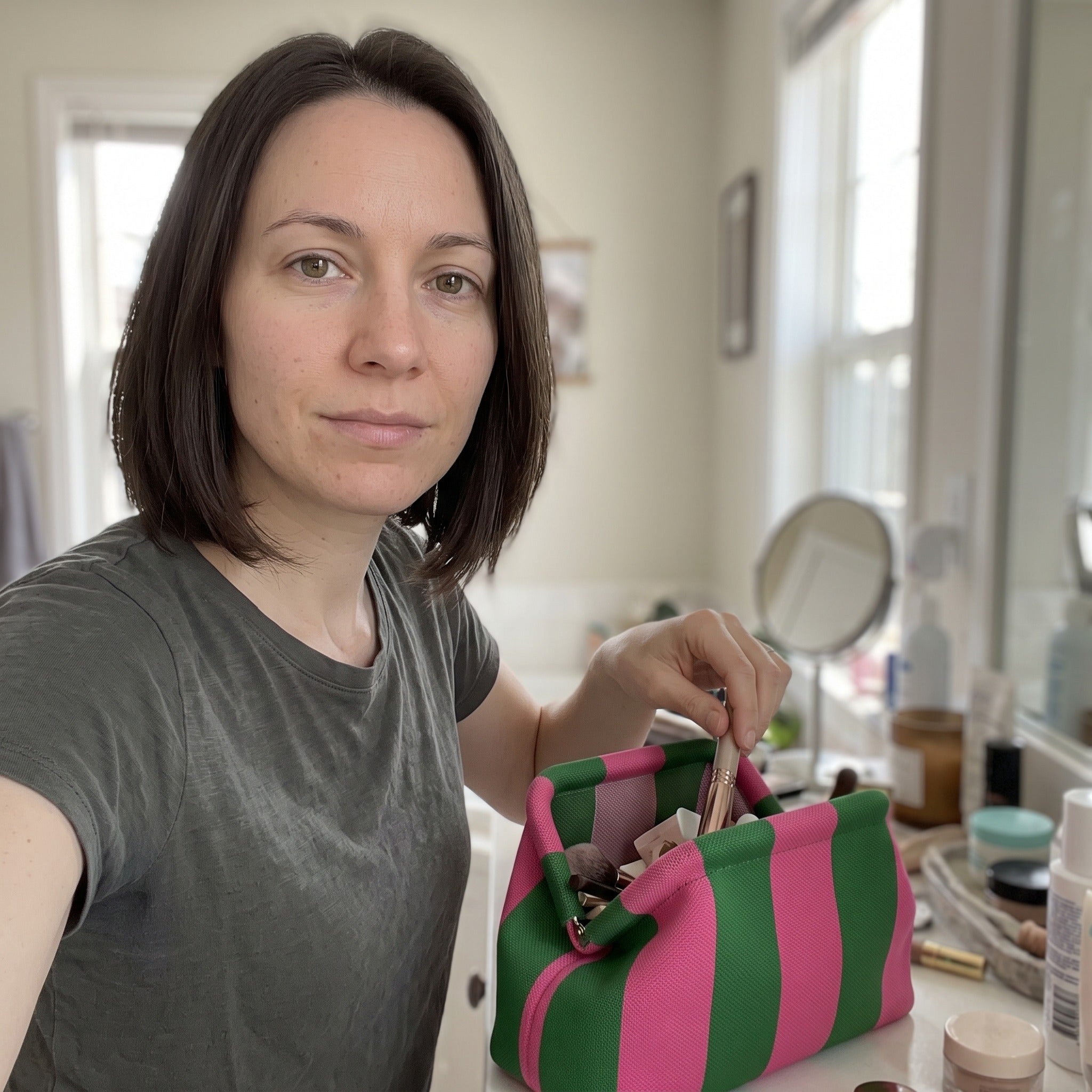 Owner scene with a striped Pop Pouch makeup bag
