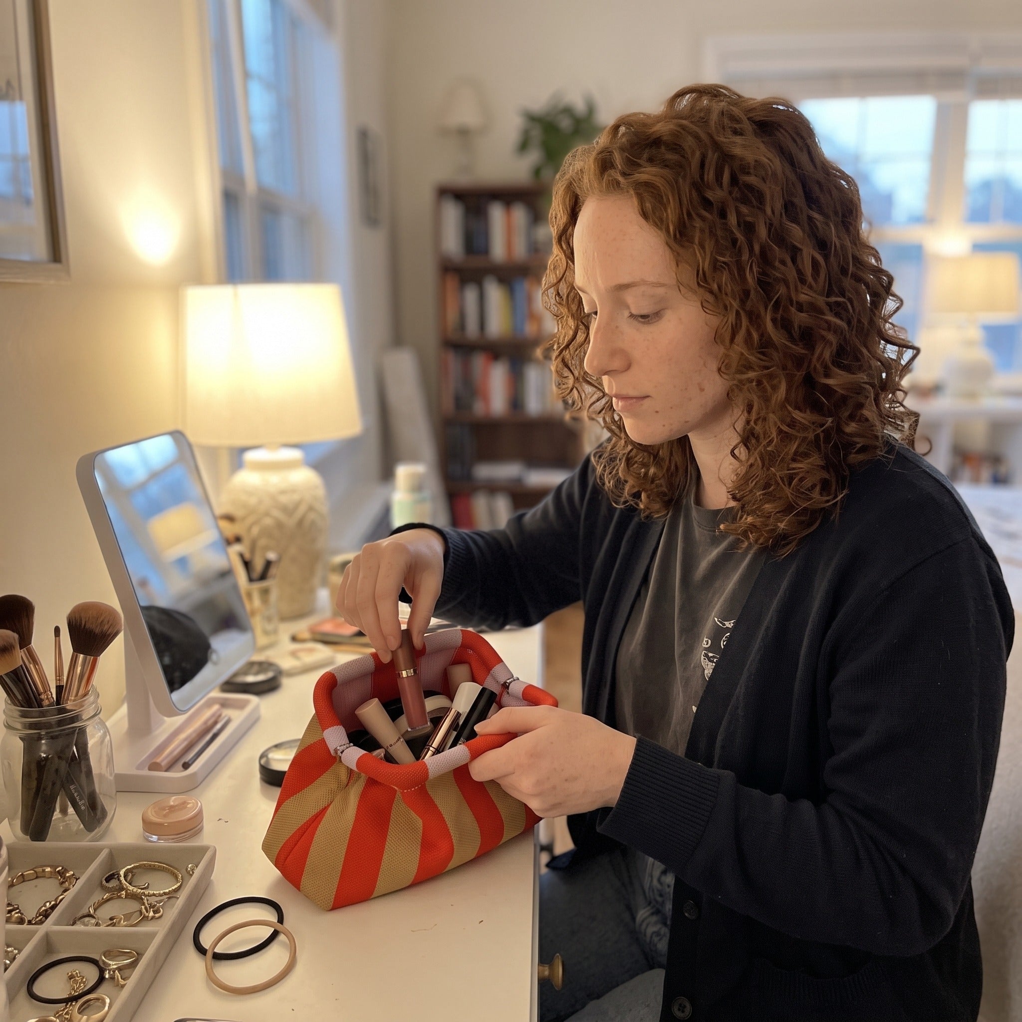 Owner scene with a striped Pop Pouch makeup bag