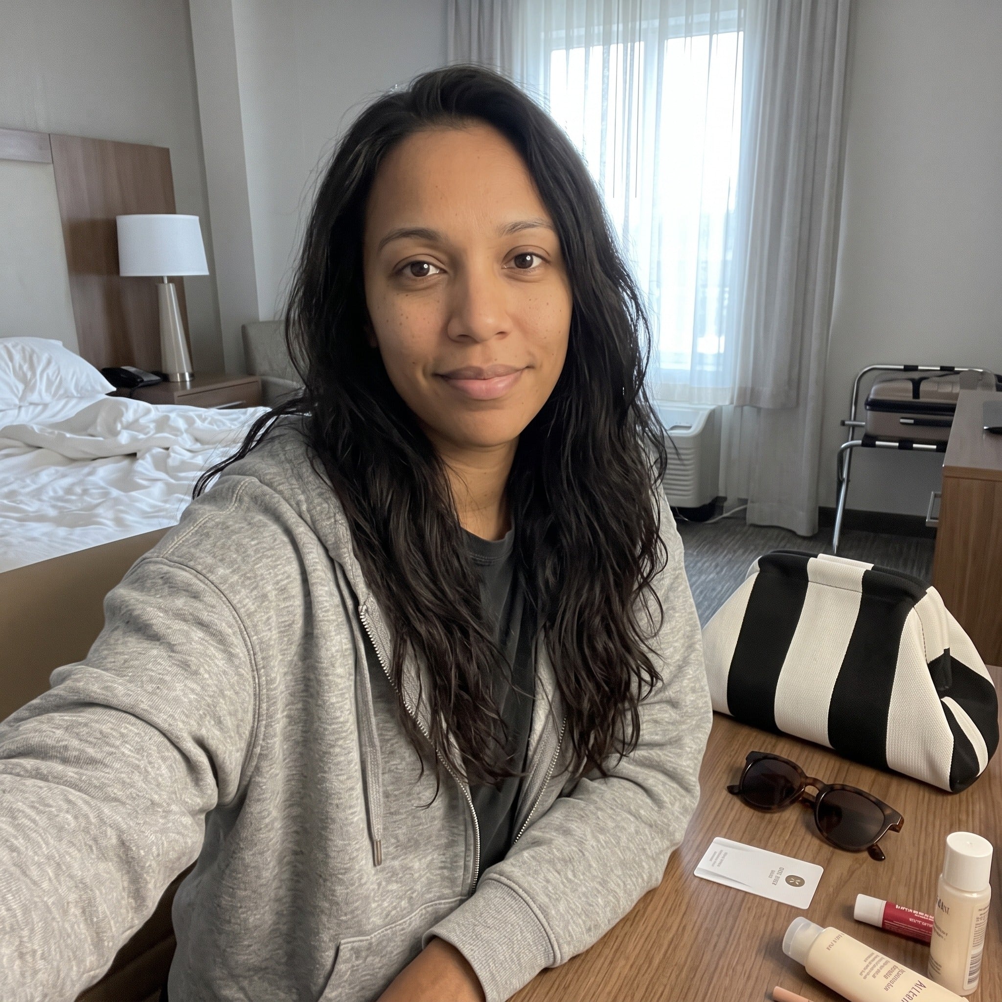 Owner scene with a striped Pop Pouch makeup bag