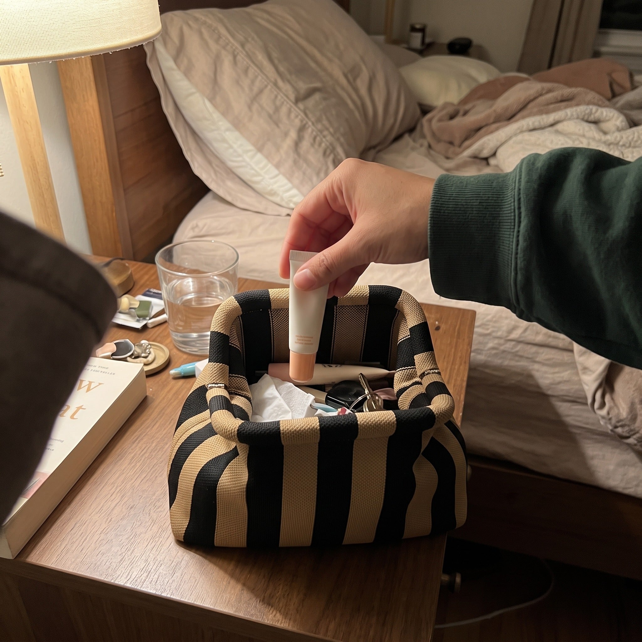 Owner scene with a striped Pop Pouch makeup bag